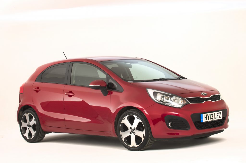 One of the smaller cars to make our list of most hated cars, the Kia Rio is featrured in cherry red, with an off-white backdrop. 