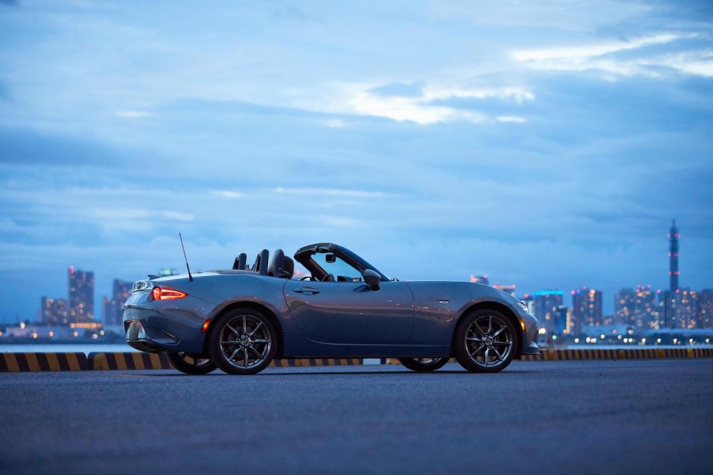 A 2021 Mazda Miata parked at sunset, the Miata is an affordable new car