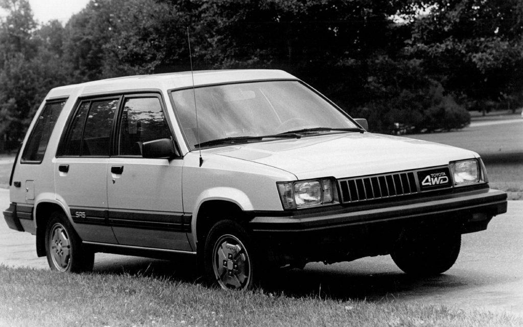 A black and white photo of the 1985 Toyota Tercel in a field. 