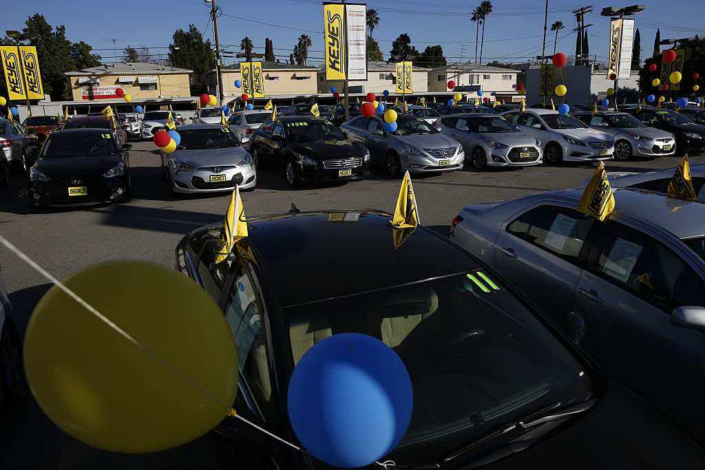 used car dealership with flags and ballons