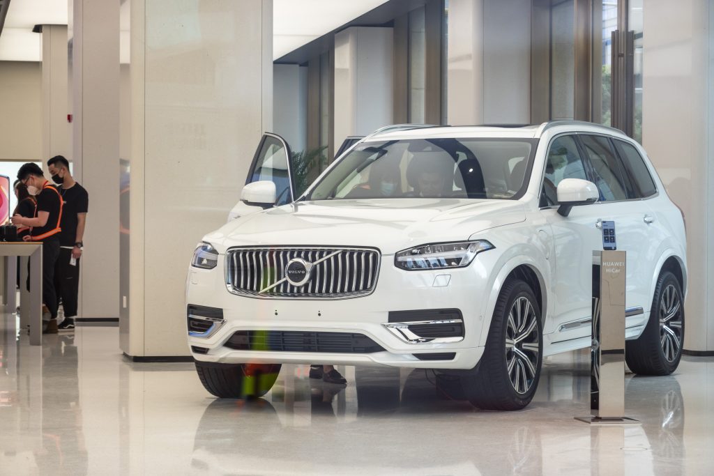 A white Volvo XC90 exemplifying Volov safety on a showroom floor.