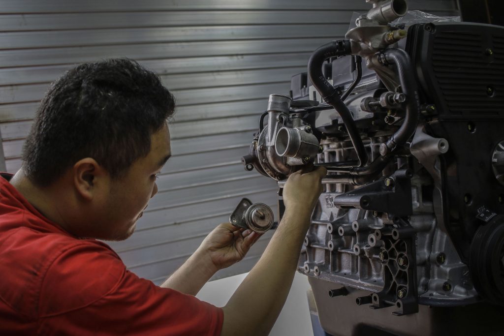 A mechanic rebuilding an engine
