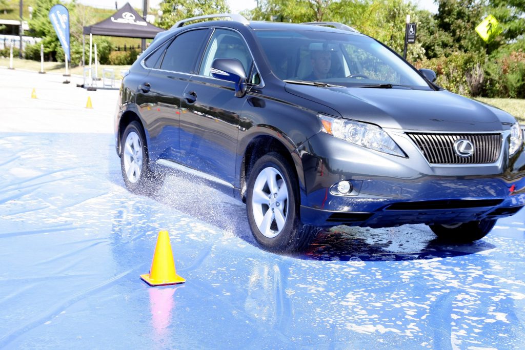 A black Lexus RX 350 SUV performing traction testing