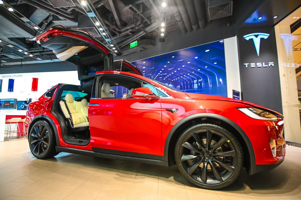 A red 2021 Tesla Model X at a car show, the Model X is the best luxury SUV for tall drivers