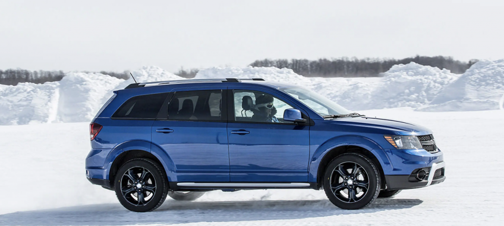 A blue Dodge Journey SUV in the snow