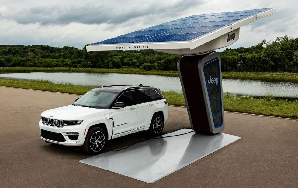The 2022 Jeep Grand Cherokee 4xe charging at a trailhead