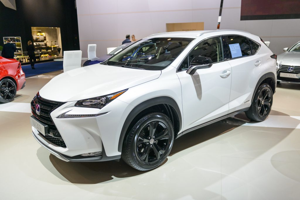 a white 2016 Lexus NX hybrid on display at an indoor auto show is an example of one of the best used lexus SUVs according to Consumer Reports 