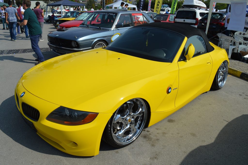 A yellow-wrapped BMW coupe