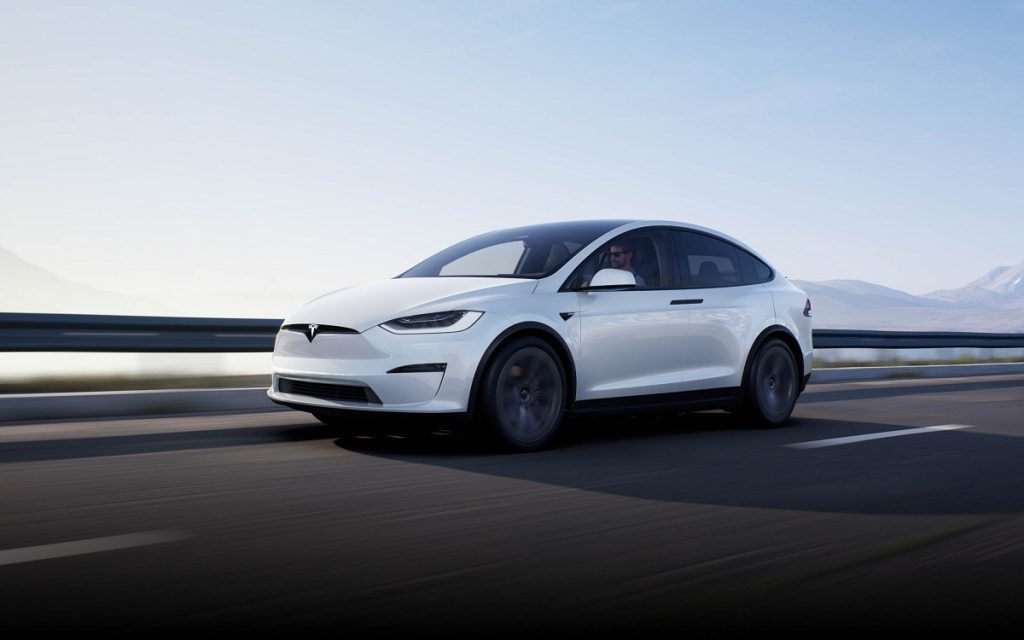 A white 2021 Tesla Model X driving down a highway exemplifies one of the best brands in terms of consumer satisfaction 
