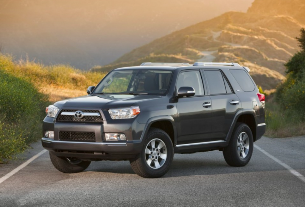 The 2013 Toyota 4Runner parked on a scenic road with mountains in the background