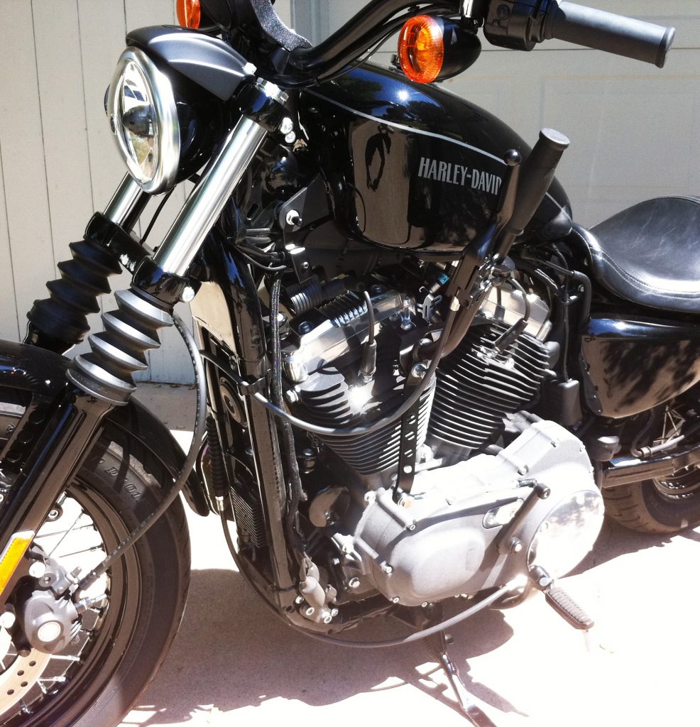 A black Harley-Davidson Sportster with a Widow Maker hand shifter kit