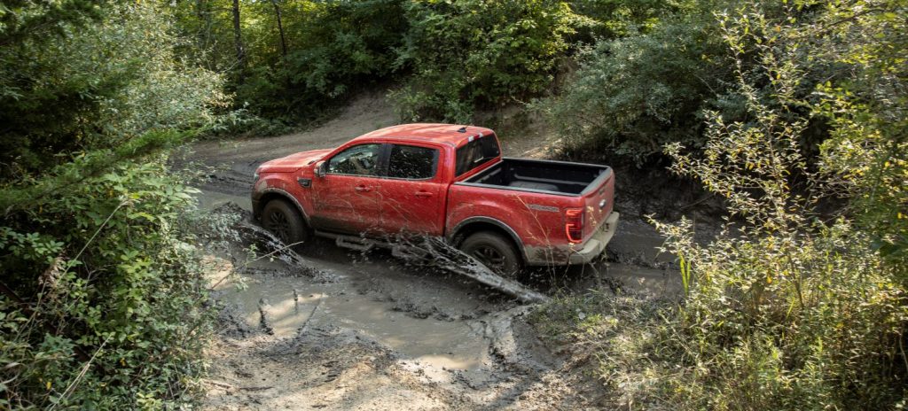 Red 2021 Ford Ranger driving on a muddy road